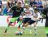 Lewis Holtby and Ryan Mason challenge their former Tottenham team-mate Clint Dempsey.