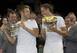 Jack Sock and Vasek Pospisil celebrate their 2014 Wimbledon doubles title.