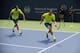 One of the Bryan brothers tosses his racket toward the ball during a doubles match in Cincinnati.