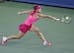 Simona Halep reaches to make a play on the ball during a match against Maria Sharapova at the Western & Southern Open in Cincinnati.