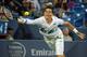 Milos Raonic reaches to make a play on the ball during a match against Roger Federer in Cincinnati.