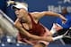 Caroline Wozniacki follows through on a serve during her quarterfinal match at the 2014 U.S. Open.