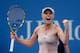 Caroline Wozniacki celebrates a win over Maria Sharapova at the 2014 U.S. Open.