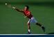 Kei Nishikori reaches to make a play on the ball during his fourth-round match at the 2014 U.S. Open.