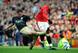 Jamie Carragher makes his presence felt with a challenge on Wayne Rooney.