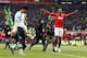 Patrice Evra coincidentally celebrates near a random Liverpool player...