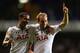 LONDON, ENGLAND - SEPTEMBER 19: Christian Eriksen of Spurs celebrates scoring their third goal with Kyle Naughton of Spurs during the UEFA Europa League Group K match between Tottenham Hotspur FC and Tromso IL at White Hart Lane on September 19, 2013 in