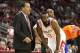 November 23, 2012; Houston, TX, USA; Houston Rockets interim head coach Kelvin Sampson (left) talks with shooting guard James Harden (13) during a timeout in the second quarter against the New York Knicks at Toyota Center. Mandatory Credit: Troy Taormina-