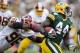 GREEN BAY, WI - SEPTEMBER 15: James Starks #44 of the Green Bay Packers rushes the ball and is pursued by Barry Cofield #96 of the Washington Redskins at Lambeau Field on September 15, 2013 in Green Bay, Wisconsin. The Packers defeated the Redskins 38-20.