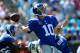 CHARLOTTE, NC - SEPTEMBER 22: Eli Manning #10 of the New York Giants drops back to pass against the Carolina Panthers during their game at Bank of America Stadium on September 22, 2013 in Charlotte, North Carolina. (Photo by Streeter Lecka/Getty Images