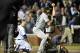 CHICAGO, IL - SEPTEMBER 23: Relief pitcher Jason Grilli #39 and catcher Russell Martin #55 of the Pittsburgh Pirates celebrate after Martin tagged out Nate Schierholtz #19 of the Chicago Cubs at home plate for the final out after Schierholtz tried to sco