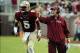 Sep 21, 2013; Tallahassee, FL, USA; Florida State Seminoles quarterback Jameis Winston (5) returns to the field after talking with head coach Jimbo Fisher during the first half of the game against the Bethune-Cookman Wildcats at Doak Campbell Stadium. Man