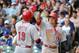 Sep 14, 2013; Milwaukee, WI, USA; Cincinnati Reds first baseman Joey Votto (left) is greeted by center fielder Shin-Soo Choo after hitting a 2-run homer in the sixth inning against the Milwaukee Brewers at Miller Park. Mandatory Credit: Benny Sieu-USA TO