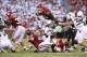 Sep 7, 2013; Norman, OK, USA; Oklahoma Sooners running back Brennan Clay (24) leaps over the pile while running with the ball in the second quarter against the West Virginia Mountaineers at Gaylord Family - Oklahoma Memorial Stadium. Mandatory Credit: Mat