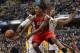 May 1, 2013; Indianapolis, IN, USA; Atlanta Hawks guard Jeff Teague (0) makes a pass under the basket against Indiana Pacers center Roy Hibbert (55) in game five of the first round of the 2013 NBA Playoffs at Bankers Life Fieldhouse. Mandatory Credit: Bri