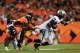 DENVER, CO - SEPTEMBER 23: Denarius Moore #17 of the Oakland Raiders breaks the tackle of Duke Ihenacho #33 and Dominique Rodgers-Cromartie #45 of the Denver Broncos to run in a 73 yard pass reception for a touchdown in the second quarter at Sports Auth