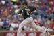 Sep 13, 2013; Arlington, TX, USA; Oakland Athletics starting pitcher Dan Straily (67) throws a pitch in the first inning of the game against the Texas Rangers at Rangers Ballpark in Arlington. Mandatory Credit: Tim Heitman-USA TODAY Sports