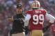 Jan 14, 2012; San Francisco, CA, USA; San Francisco 49ers head coach Jim Harbaugh (left) talks to outside linebacker Aldon Smith (99) during the second quarter of the 2011 NFC divisional playoff game against the New Orleans Saints at Candlestick Park. Man