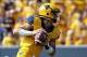 Sep 28, 2013; Morgantown, WV, USA; West Virginia Mountaineers quarterback Clint Trickett (9) drops back to pass against the Oklahoma State Cowboys at Milan Puskar Stadium. Mandatory Credit: Peter Casey-USA TODAY Sports