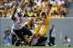 Sep 28, 2013; Morgantown, WV, USA; West Virginia Mountaineers quarterback Clint Trickett (9) avoids the pressure of Oklahoma State Cowboys defensive end Emmanuel Ogbah (38) during the second half at Milan Puskar Stadium. Mandatory Credit: Peter Casey-USA