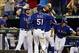 Sep 27, 2013; Arlington, TX, USA; Texas Rangers right fielder Alex Rios (51) is congratulated by first baseman Mitch Moreland (left) after scoring against the Los Angeles Angels during the seventh inning of a baseball game at Rangers Ballpark in Arlington