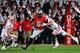Sep 28, 2013; Columbus, OH, USA; Ohio State Buckeyes quarterback Braxton Miller (5) is tackled by Wisconsin Badgers linebacker Ethan Armstrong (36) during the fourth quarter at Ohio Stadium. Ohio State Buckeyes defeated Wisconsin Badgers 31-24. Mandatory