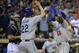 SAN DIEGO, CA - SEPTEMBER 21: Yasiel Puig #66 of the Los Angeles Dodgers is congratulated by teammate Clayton Kershaw #22 as Nick Hundley #4 of the San Diego Padres looks on after Puig hit a two-run home run during the seventh inning of a baseball game a