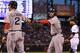 DENVER, CO - SEPTEMBER 25: Jacoby Ellsbury #2 of the Boston Red Sox and Dustin Pedroia #15 of the Boston Red Sox celebrate as they scored on a double by David Ortiz #34 of the Boston Red Sox off of starting pitcher Jhoulys Chacin #45 of the Colorado Rock