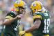 GREEN BAY, WI - SEPTEMBER 15: Aaron Rodgers #12 and Randall Cobb #18 of the Green Bay Packers celebrate after a touchdown against the Washington Redskins at Lambeau Field on September 15, 2013 in Green Bay, Wisconsin. The Packers defeated the Redskins 38-