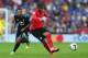 CARDIFF, WALES - SEPTEMBER 22: Fraizer Campbell (R) of Cardiff City passes as Moussa Dembele (L) of Tottenham Hotspur looks on during the Barclays Premier League match between Cardiff City and Tottenham Hotspur at Cardiff City Stadium on September 22, 201
