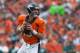 DENVER, CO - SEPTEMBER 29: Quarterback Peyton Manning #18 of the Denver Broncos rolls out of the pocket and looks for a receiver downfield against the Philadelphia Eagles at Sports Authority Field Field at Mile High on September 29, 2013 in Denver, Color