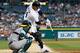 DETROIT, MI - AUGUST 28: Miguel Cabrera #24 of the Detroit Tigers hits a third inning single in front of Kurt Suzuki #22 of the Oakland Athletics at Comerica Park on August 28, 2013 in Detroit, Michigan. (Photo by Gregory Shamus/Getty Images)