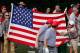 DUBLIN, OH - OCTOBER 04: A fan offers a toy squirrel to Keegan Bradley (L) and Phil Mickelson of the U.S. Team on the second hole during the Day Two Foursome Matches at the Muirfield Village Golf Club on October 4, 2013 in Dublin, Ohio. (Photo by Greg