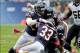 Oct 6, 2013; Chicago, IL, USA; Chicago Bears cornerback Charles Tillman (33) and outside linebacker James Anderson (50) and defensive end David Bass (91) and middle linebacker D.J. Williams (58) tackle New Orleans Saints running back Pierre Thomas (23) du