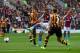 HULL, ENGLAND - OCTOBER 05: Andreas Weimann of Aston Villa takes a shot on goal as Jake Livermore of Hull closes in during the Barclays Premier League match between Hull City and Aston Villa at KC Stadium on October 5, 2013 in Hull, England. (Photo by J