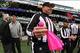 Oct 28, 2012; East Rutherford, NJ, USA; NFL umpire Butch Hannah (40) shows the pink flag presented to him by 11 year old Dante Cano before the game between the New York Jets and the Miami Dolphins at MetLIfe Stadium. Mandatory Credit: Ed Mulholland-USA TO