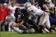 Oct 5, 2013; Evanston, IL, USA; Northwestern Wildcats running back Venric Mark (5) is tackled by Ohio State Buckeyes defensive lineman Joey Bosa (97) and defensive lineman Noah Spence (8) during the third quarter at Ryan Field. Ohio State won 40-30. Manda