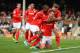 LONDON, ENGLAND - SEPTEMBER 28: Jordan Mutch of Cardiff is mobbed by his team mates as he celebrates on his knees after scoring their winning goal during the Barclays Premier League match between Fulham and Cardiff City at Craven Cottage on September 28,