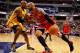 INDIANAPOLIS, IN - OCTOBER 05: David West #21 of the Indiana Pacers defends as Carlos Boozer #5 of the Chicago Bulls dribbles the ball on the baseline on October 5, 2013 at Bankers Life Fieldhouse in Indianapolis, Indiana. Chicago defeated Indiana 82-76.