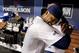 Hanley Ramirez bear hugs Uribe in the dugout.