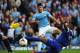 MANCHESTER, ENGLAND - OCTOBER 05: Sergio Aguero of Manchester City shoots past Sylvain Distin (R) and Tim Howard (L) of Everton to score his team's second goal during the Barclays Premier League match between Manchester City and Everton at Etihad Stadium