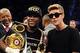 Sep 14, 2013; Las Vegas, NV, USA; Floyd Mayweather Jr (left) and Justin Bieber appear in the ring after Mayweather defeated Canelo Alvarez by a majority decision at their WBC and WBA super welterweight titles fight at MGM Grand Garden Arena. Mandatory Cr