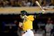 OAKLAND, CA - OCTOBER 05: Josh Donaldson #20 of the Oakland Athletics hits a single to center field in the fourth inning against Justin Verlander #35 of the Detroit Tigers during Game Two of the American League Division Series at O.co Coliseum on October
