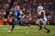 Oct 5, 2013; Gainesville, FL, USA; Florida Gators quarterback Tyler Murphy (3) scrambles out of the pocket away from defender Arkansas Razorbacks linebacker Jarrett Lake (39) during the first half of the game at Ben Hill Griffin Stadium. Mandatory Credit: