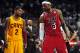 Feb 24, 2013; Miami, FL, USA; Cleveland Cavaliers point guard Kyrie Irving (left) looks over at Miami Heat small forward LeBron James (right) as Cleveland Cavaliers head coach Byron Scott (center) looks on during the second half at the American Airlines A