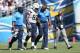 SAN DIEGO, CA - SEPTEMBER 29: Outside linebacker Dwight Freeney (2nd from left) #93 of the San Diego Chargers walks off the field with staff members in the first half against the Dallas Cowboys at Qualcomm Stadium on September 29, 2013 in San Diego, Cali