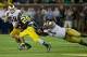 Sep 7, 2013; Ann Arbor, MI, USA; Michigan Wolverines running back Fitzgerald Toussaint (28) carries the ball as Notre Dame Fighting Irish nose tackle Louis Nix (1) and linebacker Jarrett Grace (59) defend in the third quarter at Michigan Stadium. Michigan
