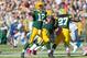 GREEN BAY, WI - OCTOBER 6: Aaron Rodgers #12 of the Green Bay Packers passes the ball against the Detroit Lions defense at Lambeau Field on October 6, 2013 in Green Bay, Wisconsin. (Photo Tom Lynn /Getty Images)