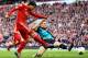 LIVERPOOL, ENGLAND - MARCH 03: Thomas Vermaelen of Arsenal attempts to block the shot by Luis Suarez of Liverpool during the Barclays Premier League match between Liverpool and Arsenal at Anfield on March 3, 2012 in Liverpool, England. (Photo by Clive M