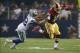 Oct 13, 2013; Arlington, TX, USA; Washington Redskins quarterback Robert Griffin III (10) tries to avoid the tackle of Dallas Cowboys cornerback Orlando Scandrick (32) during the game at AT&T Stadium. The Dallas Cowboys beat the Washington Redskins 31-16.